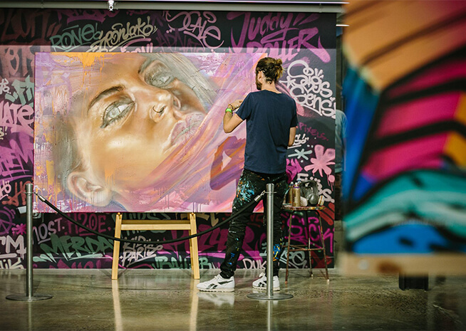 Artist Adnate doing a live painting for LCI Melbourne auction
